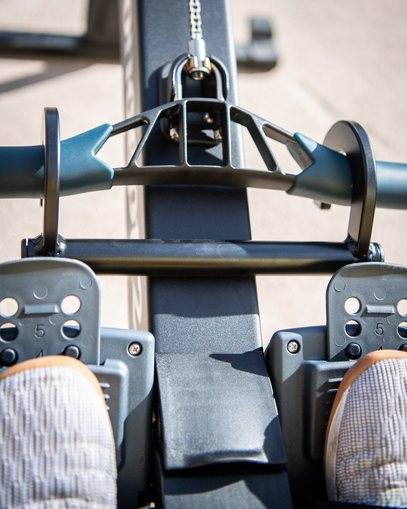 Rower Handle / Hook sitting static on the handle of a Concept2 Rower looking down toward the ground.