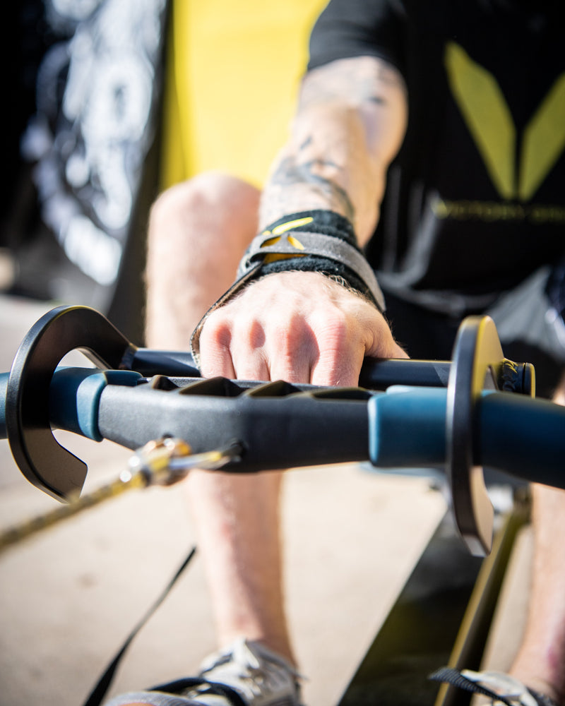 Rower hook on the rower being used in action by an athlete using his right hand.