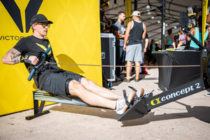 Pictured from the side Logan Aldridge using the Rower Handle / Hook on a Concept2 Rower in the Victory Grips Booth Wodapalooza 2018