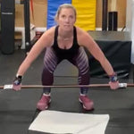 Kym Dekeyrel, a visually impaired athlete, using a barbell performing a snatch lift using the Equip Barbell Markers to assure proper hand placement.